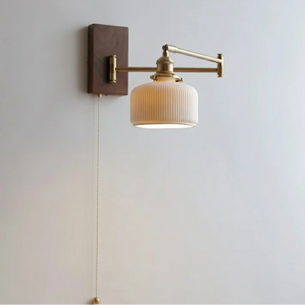 Walnut wall lamp with ceramic shade and swiveling copper arm