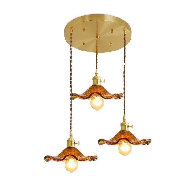 Three-bulb amber glass pendant light in an elegant vintage style