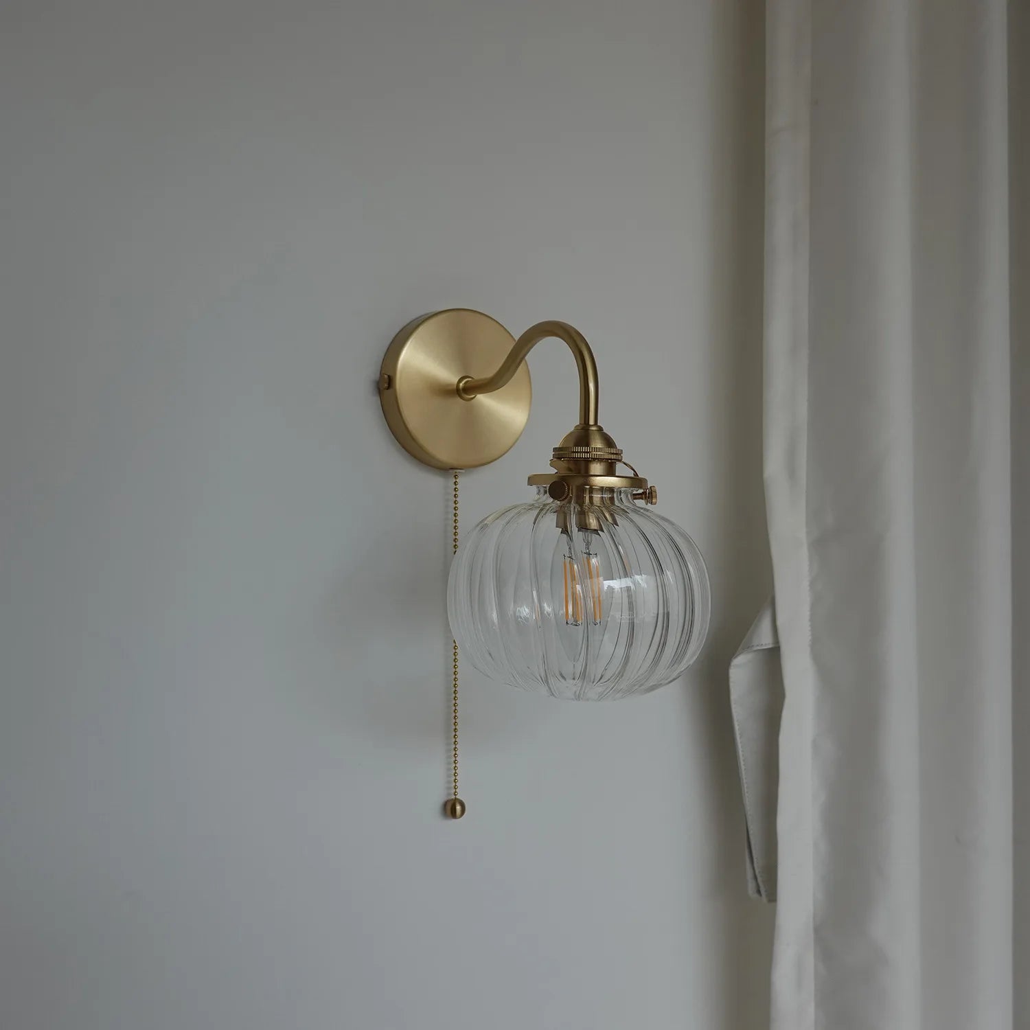 Vintage glass ball wall lamp with elegant brass arch