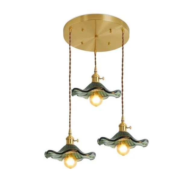 Three-bulb emerald glass pendant light in a warm vintage style