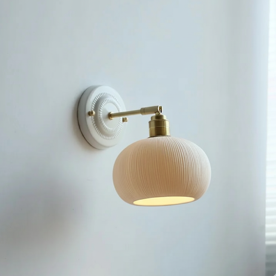 Wall lamp with round ceramic ribbed shade and brass arm