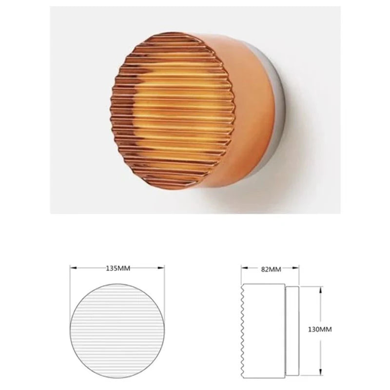 Round LED wall light with grooved acrylic and warm ambient light