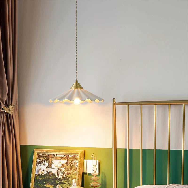 Large ceramic pendant light with a wavy vintage shade in copper.