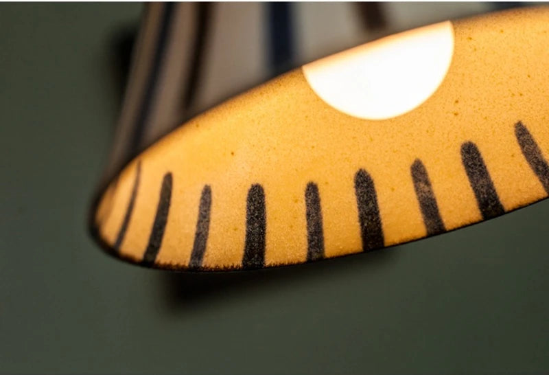 Ceramic pendant light with hand-painted striped pattern