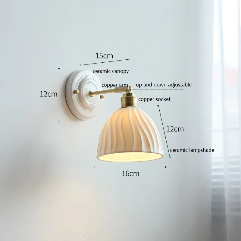 Wall lamp with grooved ceramic shade and brass arm