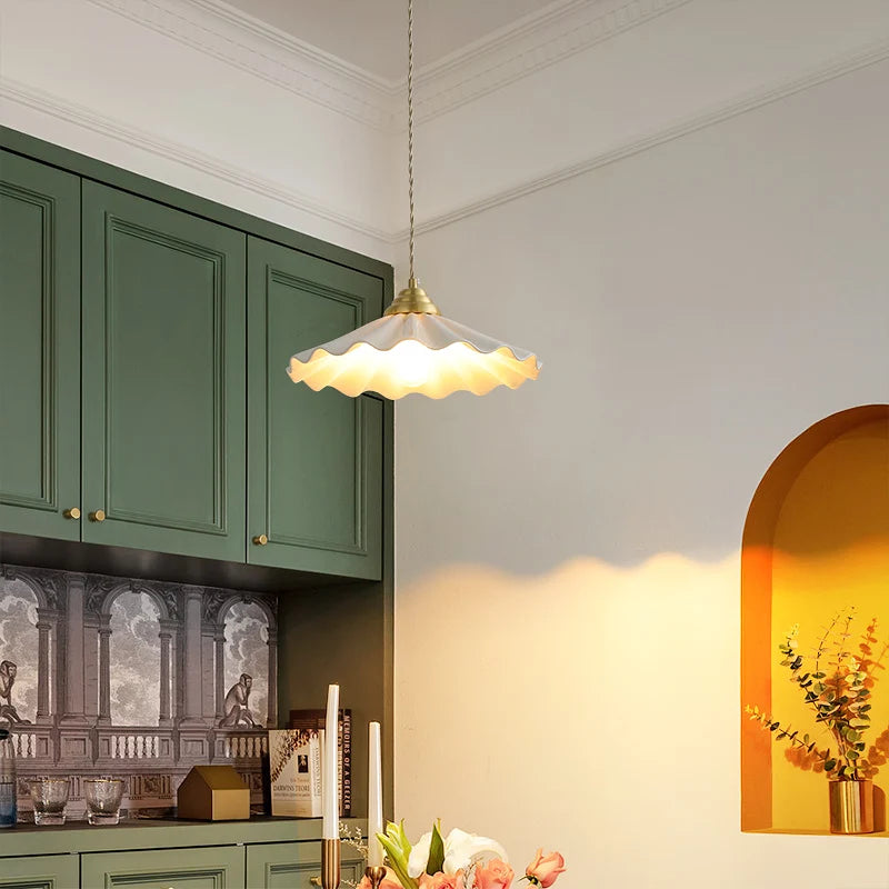 Large ceramic pendant light with a wavy vintage shade in copper.