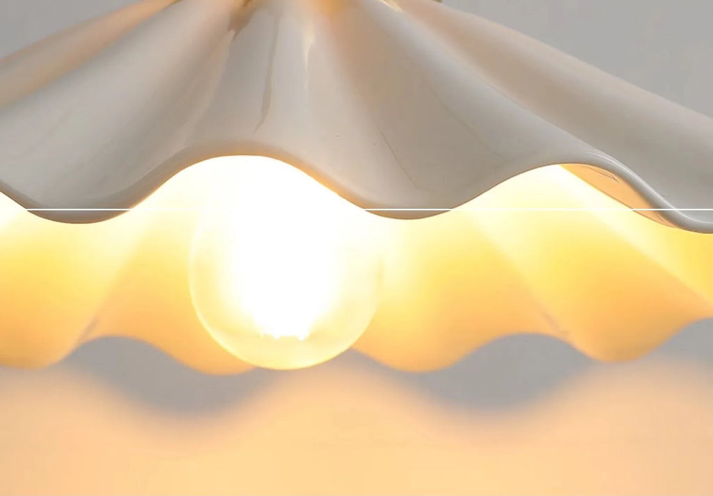 Large ceramic pendant light with a wavy vintage shade in copper.