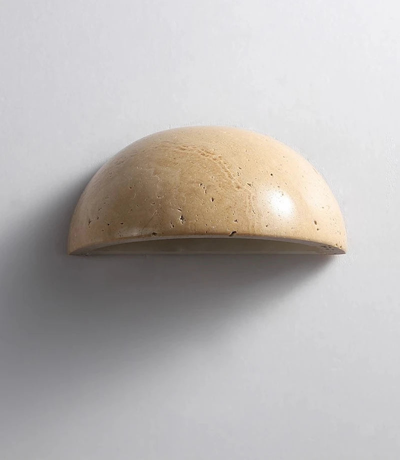 Semi-circular travertine wall light for warm, natural ambient light