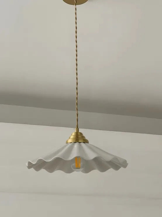 Large ceramic pendant light with a wavy vintage shade in copper.