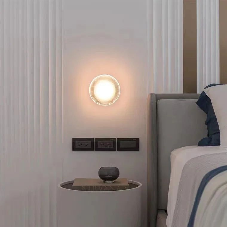 Round acrylic wall lamp with a soft vintage glow.