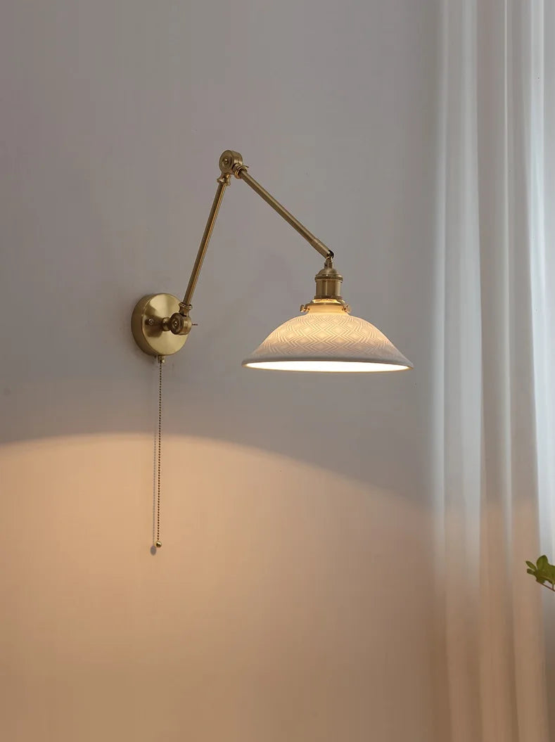 Vintage brass wall lamp with a wide ceramic shade