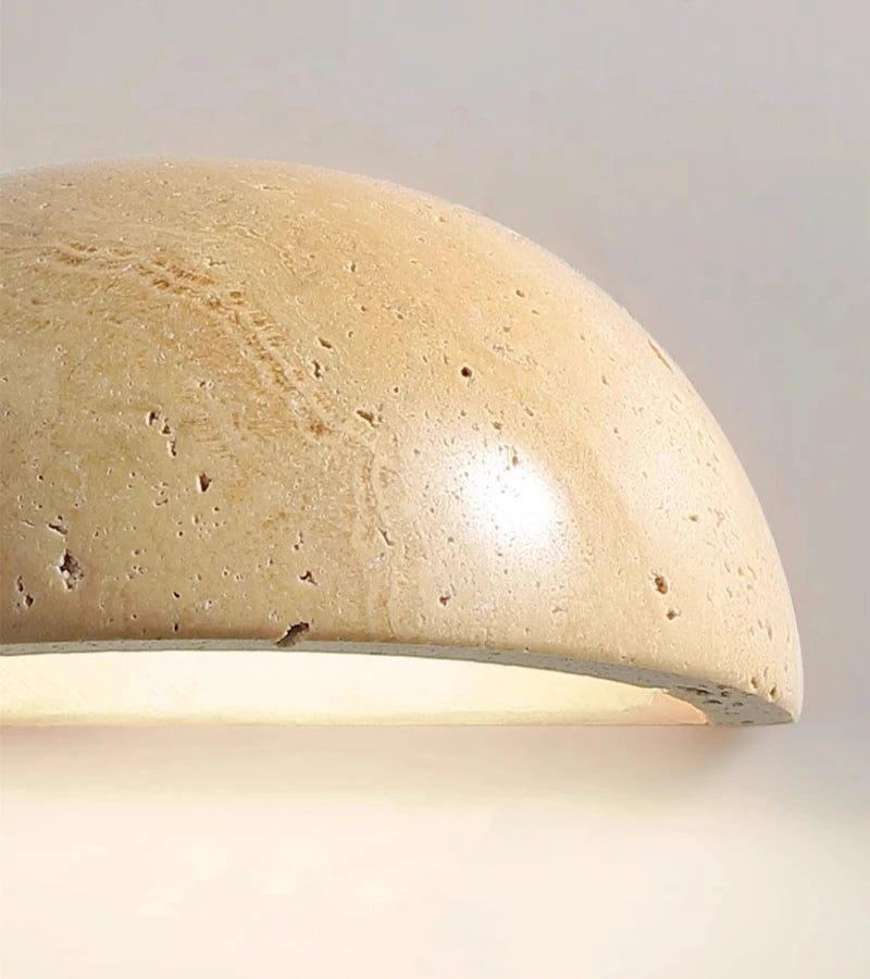 Semi-circular travertine wall light for warm, natural ambient light