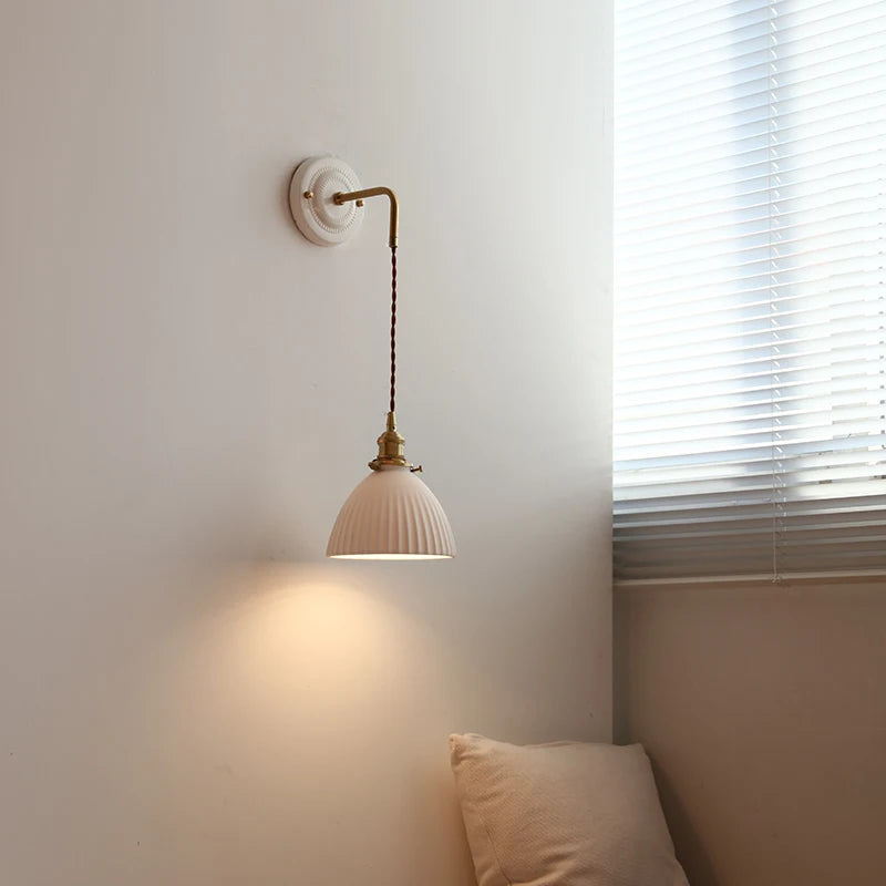 Ceramic wall lamp with gently curved vintage shade and copper arm