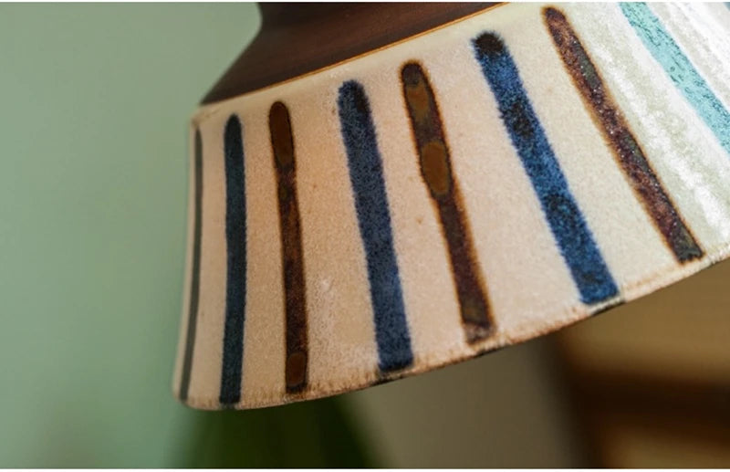 Ceramic pendant light with hand-painted striped pattern