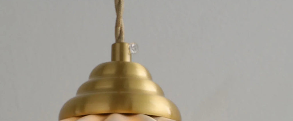 Large ceramic pendant light with a wavy vintage shade in copper.