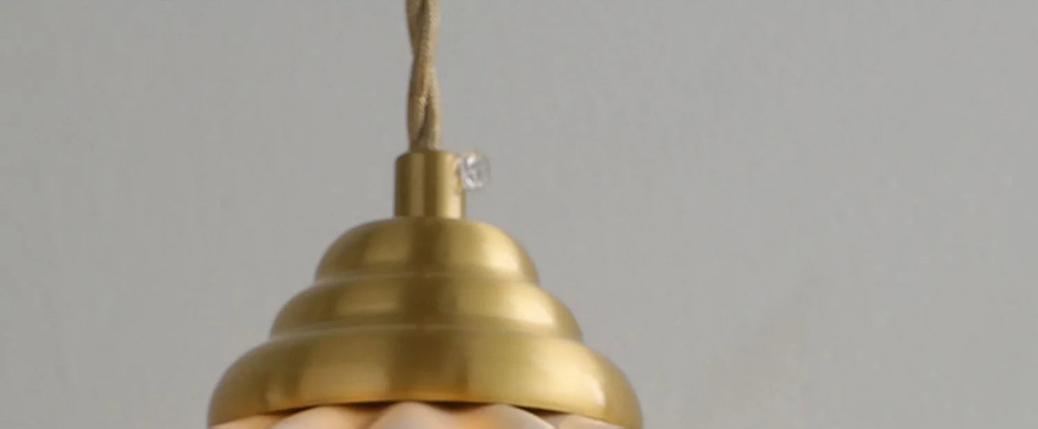 Large ceramic pendant light with a wavy vintage shade in copper.