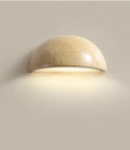 Semi-circular travertine wall light for warm, natural ambient light