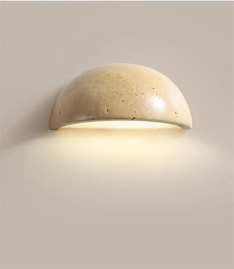 Semi-circular travertine wall light for warm, natural ambient light