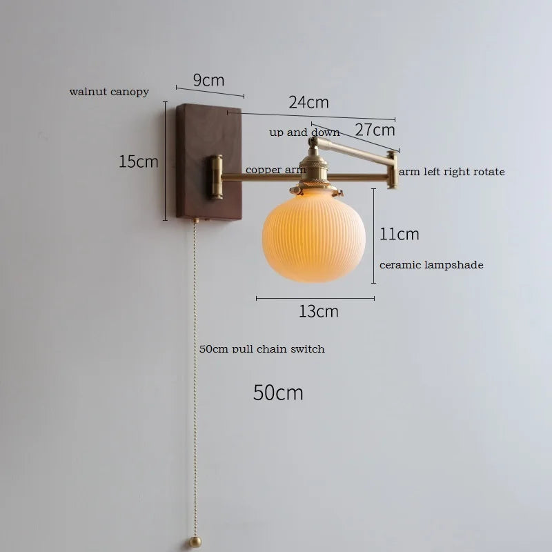 Walnut wall lamp with round ceramic shade and swiveling copper arm