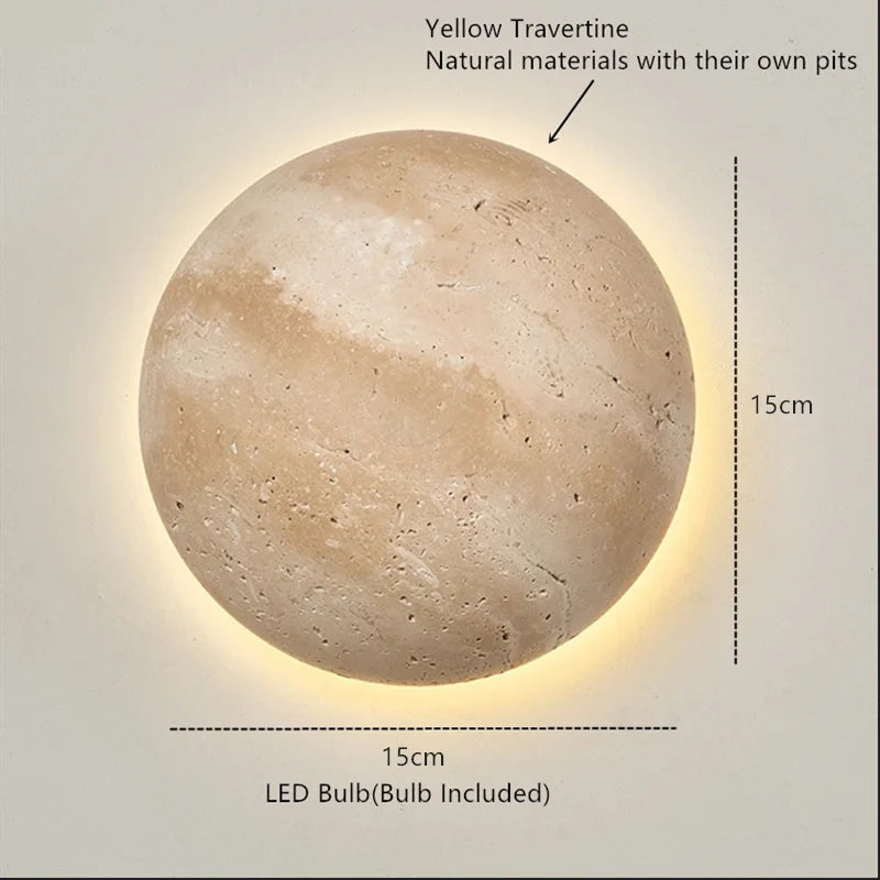 Round travertine wall light with warm backlighting in a natural stone look