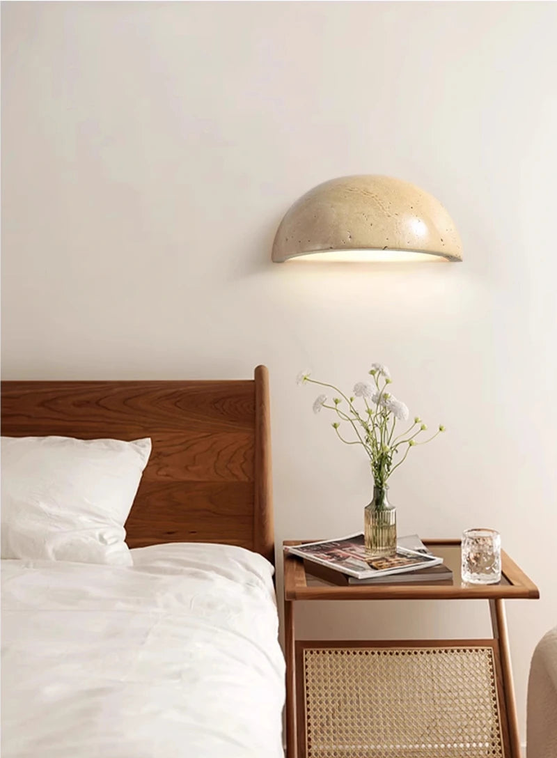 Semi-circular travertine wall light for warm, natural ambient light