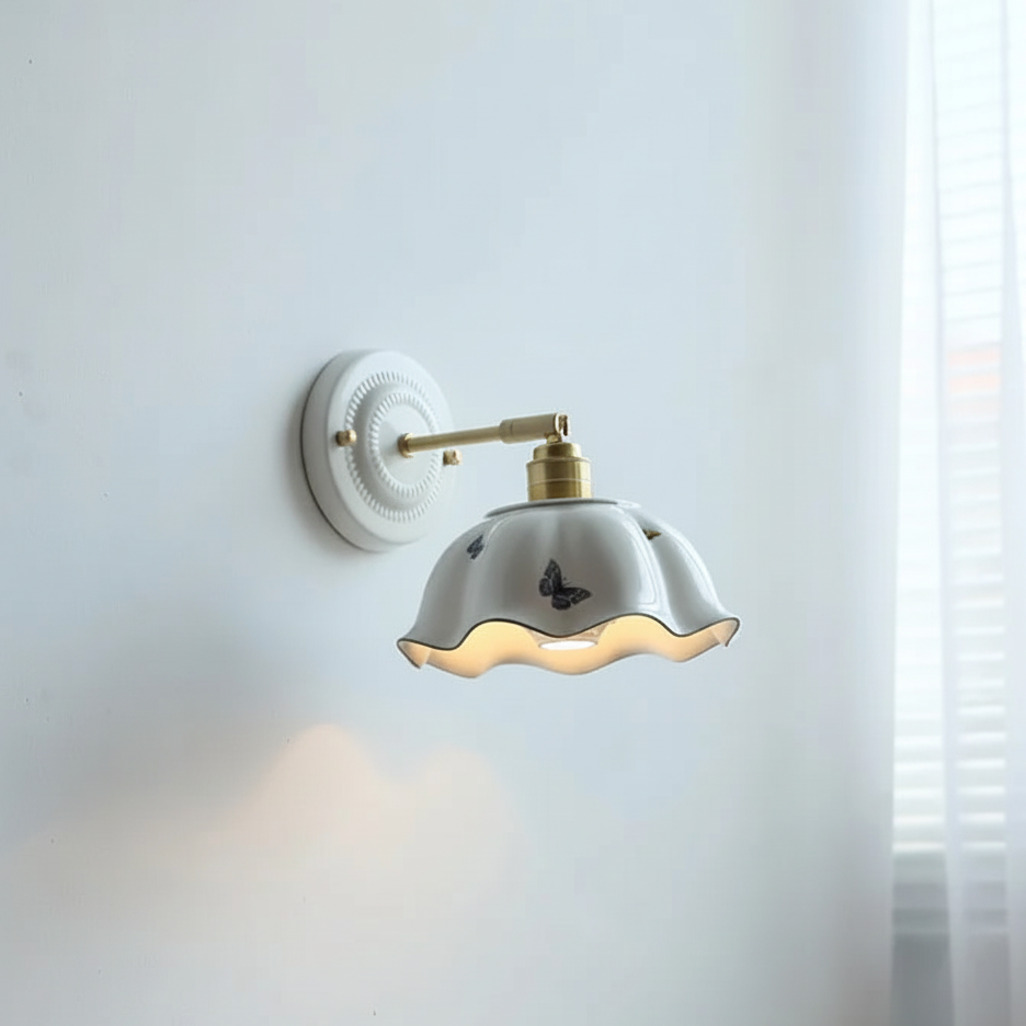 Wall lamp with wavy ceramic shade and delicate butterfly details